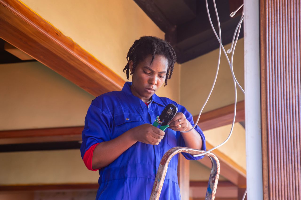 The Art of Drawing Readers In: Your attractive post title goes here Professional electrician working on wiring in an indoor setting, demonstrating skill and concentration.