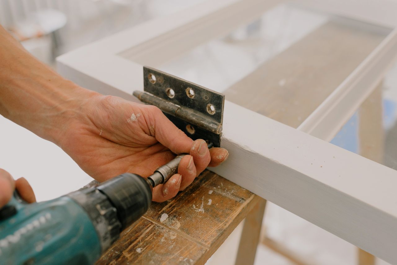 Crafting Captivating Headlines: Your awesome post title goes here Crop unrecognizable worker drilling metal hinge on white window frame during house renovation